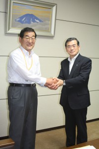 握手を交わす村長と市長